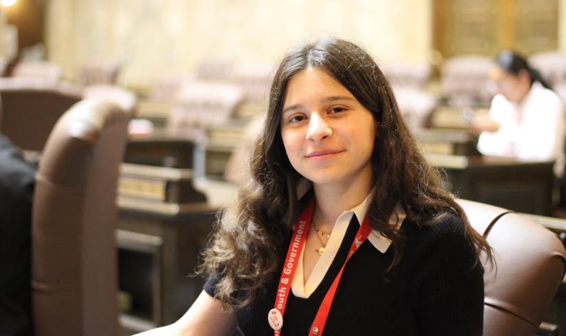 youth and government student poses in the Washington State Capitol during a hearing.