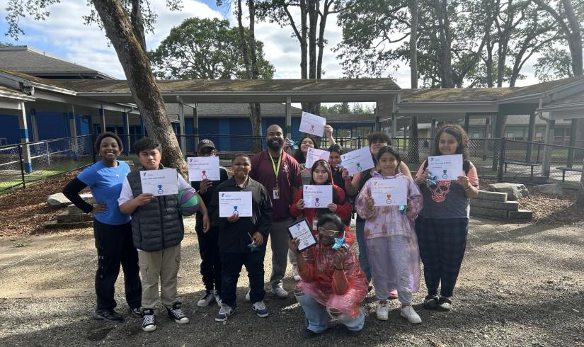 CLC students pose with their academic achievement certificates at the YMCA