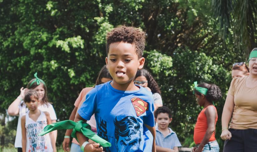 Image of youth running through play field