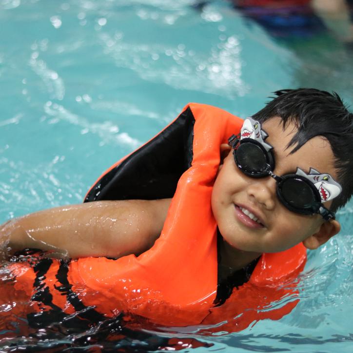 Youth in personal floatation device in our summer swimming program