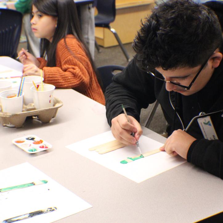 Site Leader Sean Chavez 18, working on an art project with the After School Care participants   