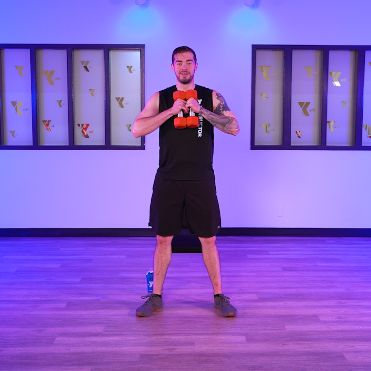 YMCA360 Instructor Bryce holds free weights and leads a newly released class. 