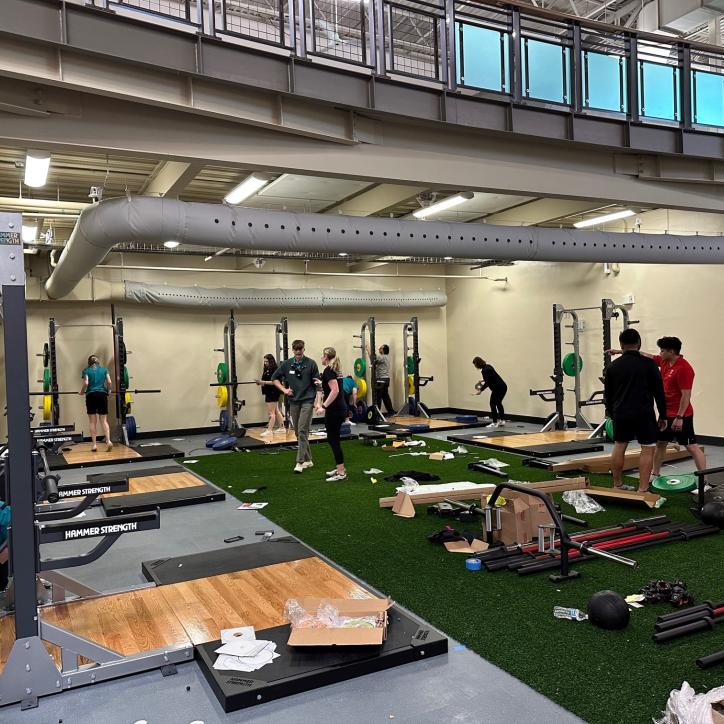 YMCA staff work to set up a renovated work out area