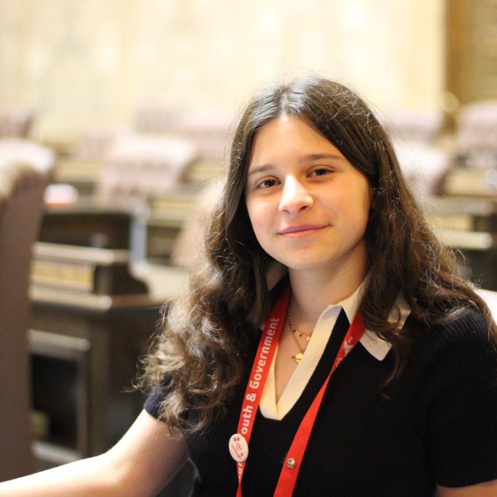 youth and government student poses in the Washington State Capitol during a hearing.