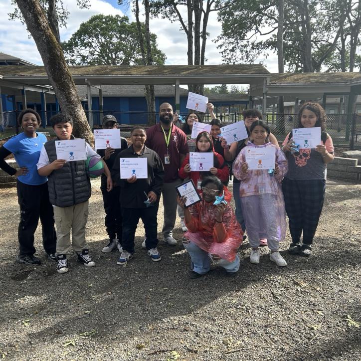 CLC students pose with their academic achievement certificates at the YMCA