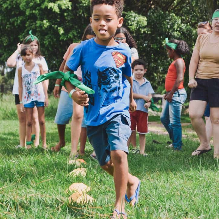 Image of youth running through play field