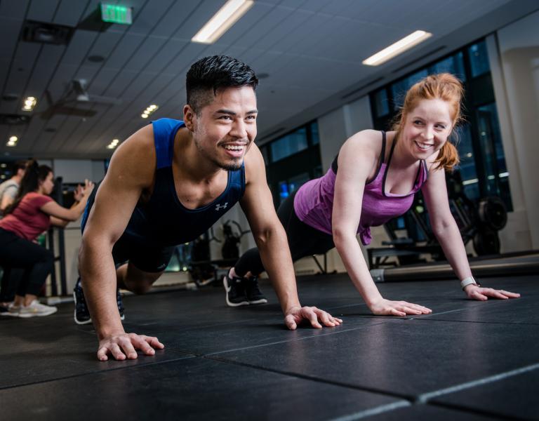 Push Ups In A YMCA Cardio and Strength Group Exercise Class