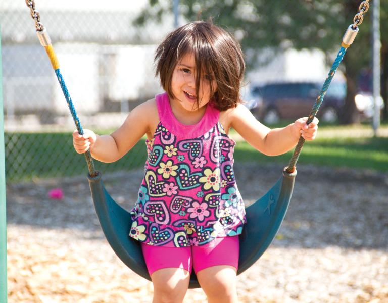 Smiling and Swinging At YMCA Child Care