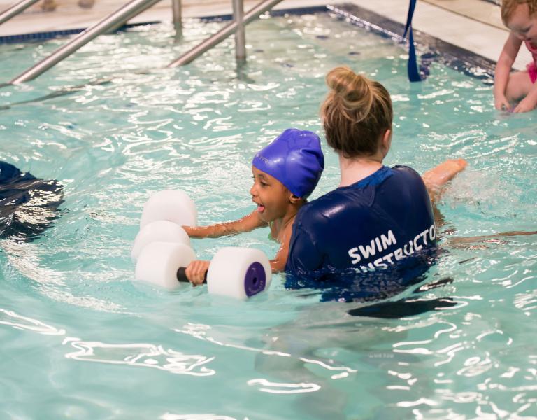 Instructor Helping With Floaties At YMCA Swim Lessons