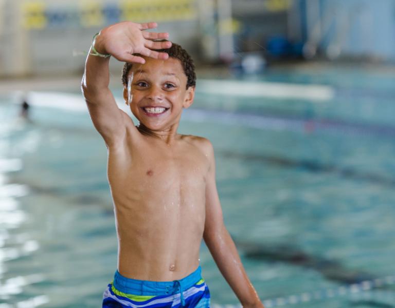 Boy Waving After Swim At YMCA Lap Pool