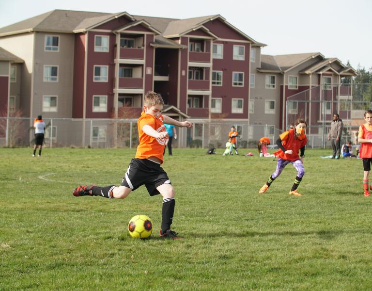 Shooting A Goal At YMCA Youth Soccer