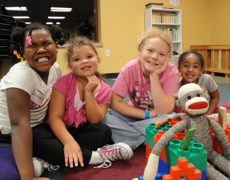 KNO youth posing with toys