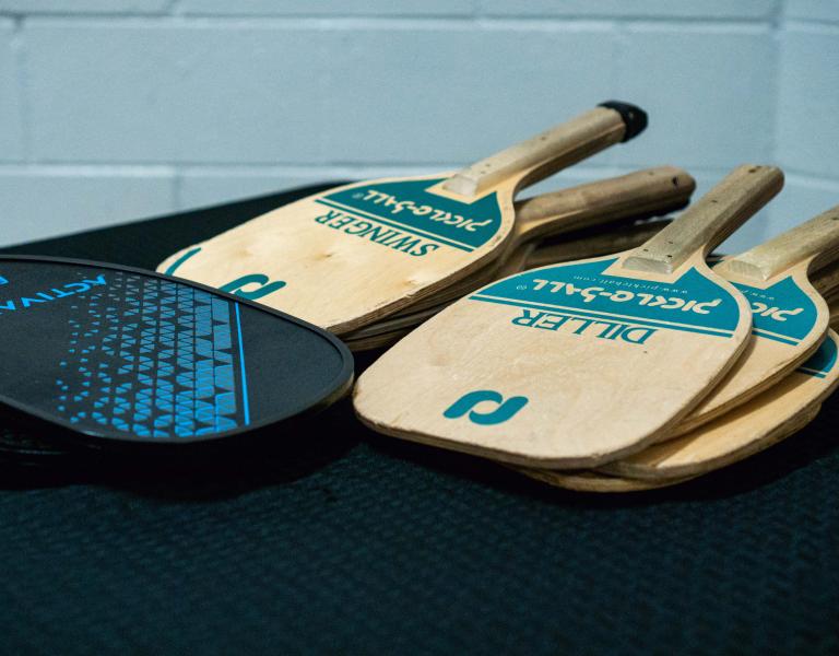 Pickleball paddles laying on a table