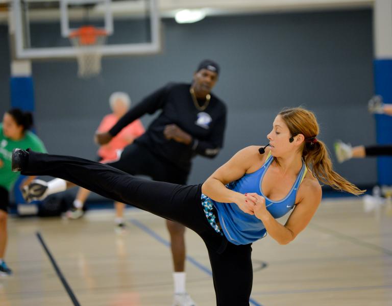 Instructor leading a cardio class at the Y