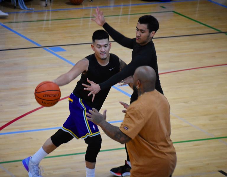 Action shot of a two man defense drill in the middle of a YMCA basketball game