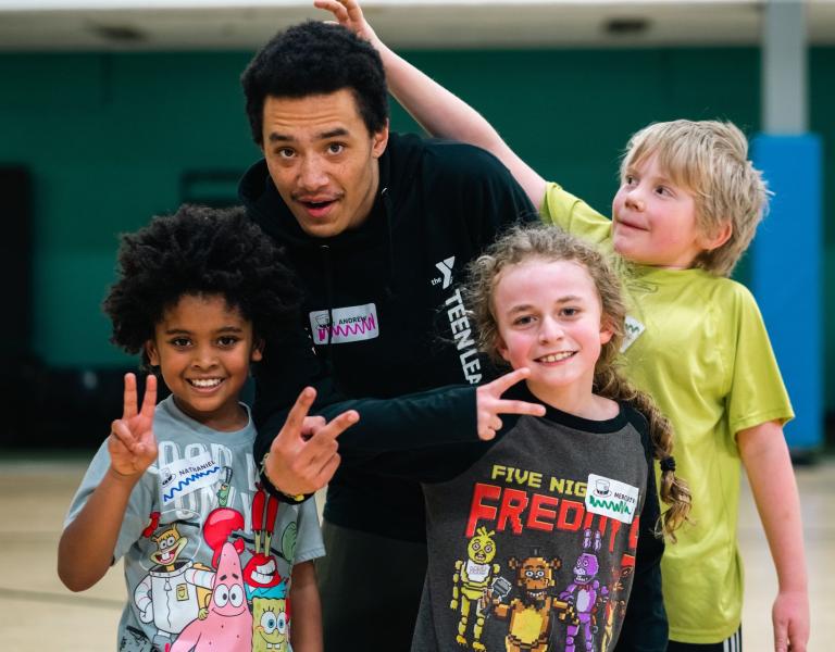 Kids night out group poses with peace signs at the YMCA