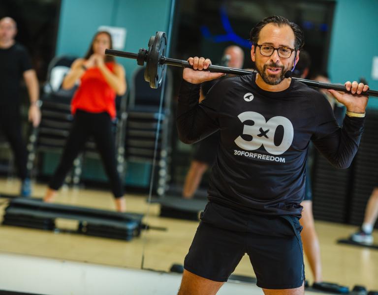 High intensity workout instructor leading class at the YMCA