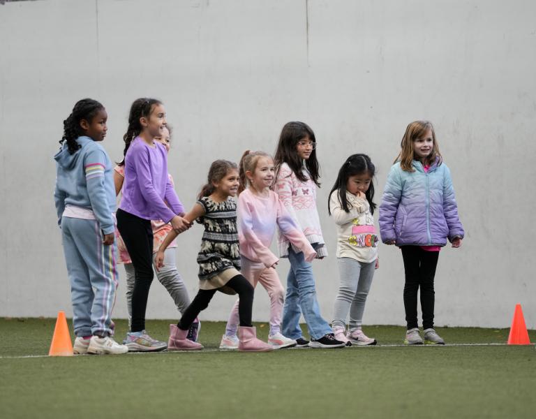 Summer camp campers line up for a field activity during camp at the YMCA