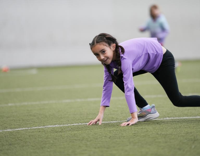 Break camp participant lines up for a sprint in the indoor turf at the YMCA