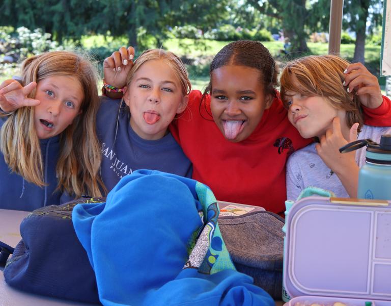 Campers pose for a picture during lunchtime at camp at the YMCA