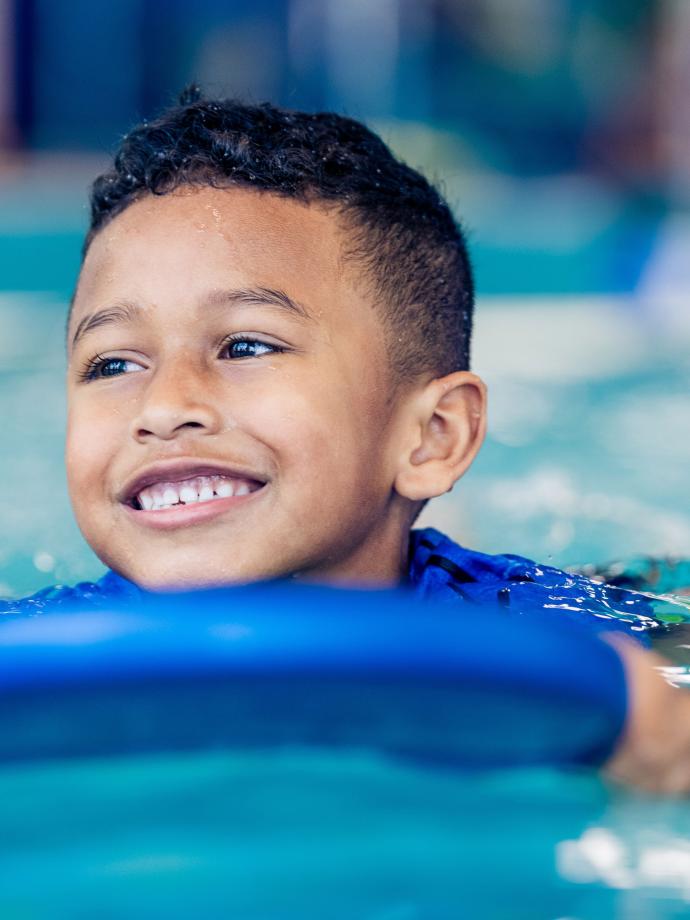 YMCA Youth Swim Lessons - Child On Paddle Board