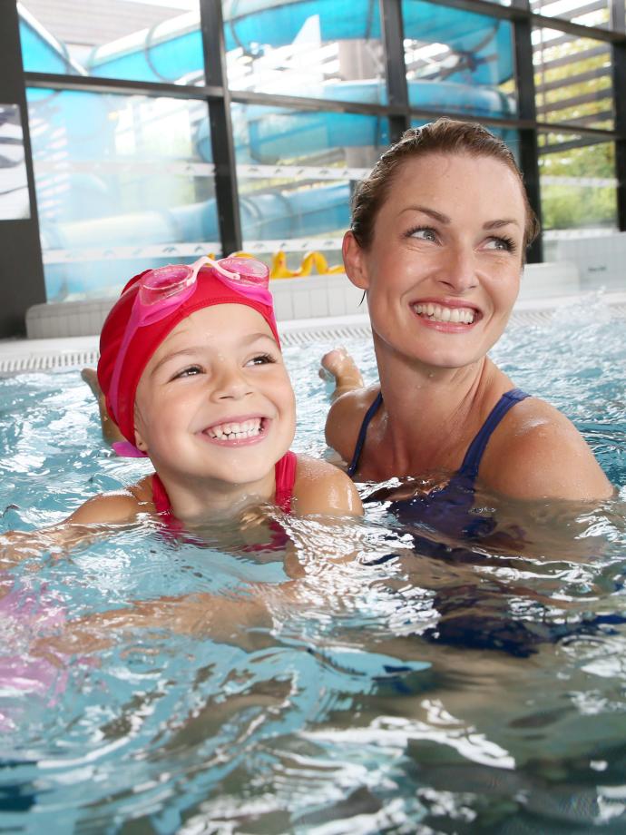 Mother and Daughter Having Fun In The Pool