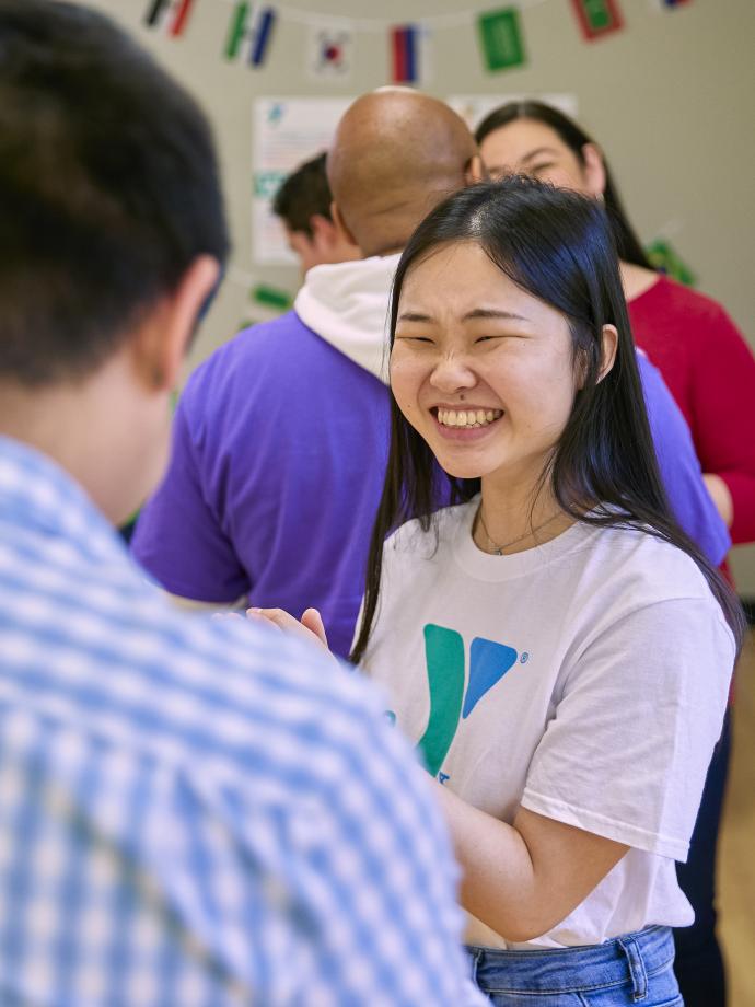 People gather in a YMCA Community Room in celebration of Welcoming Week 2022