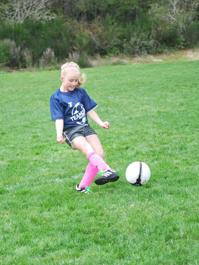Youth soccer player preparing to stop the ball