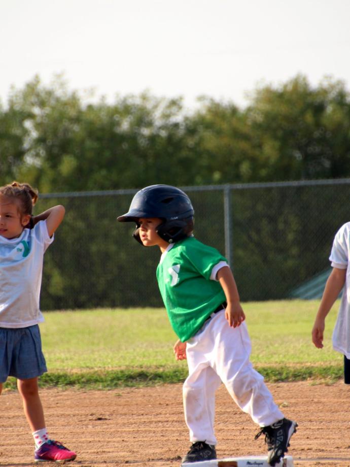 T-ball player leading off on base