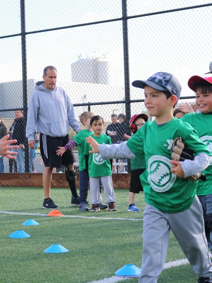 T-ball teams lined up for post game high fives