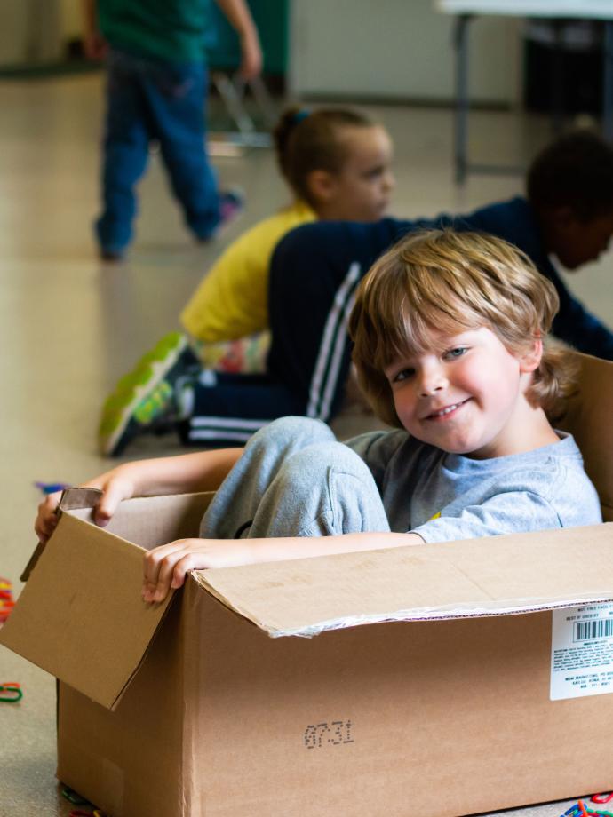 Camper Having Fun With Box at YMCA Summer Day Camp