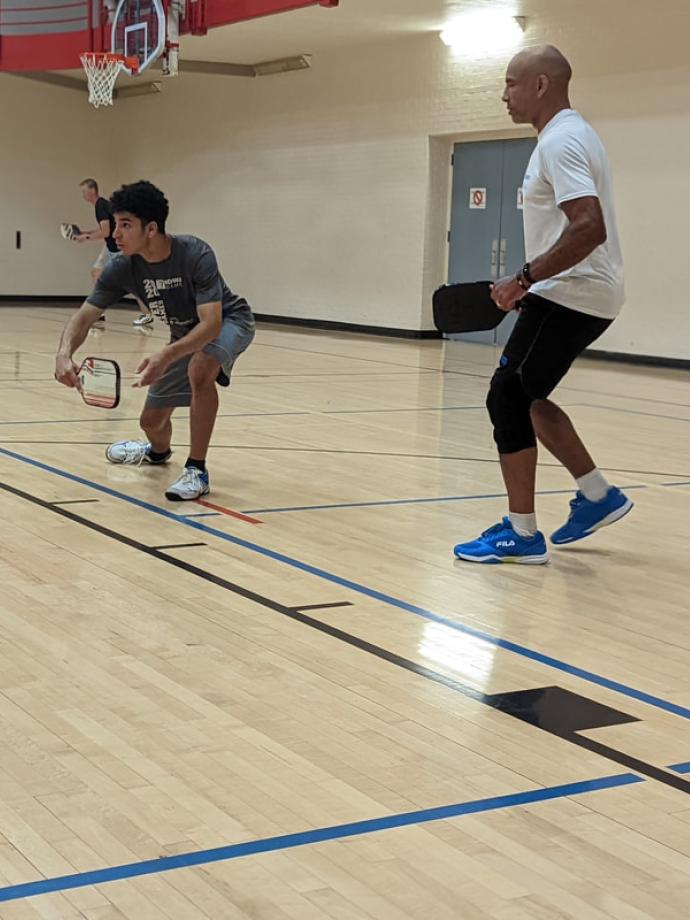 Pickleball doubles team ready up to return a shot