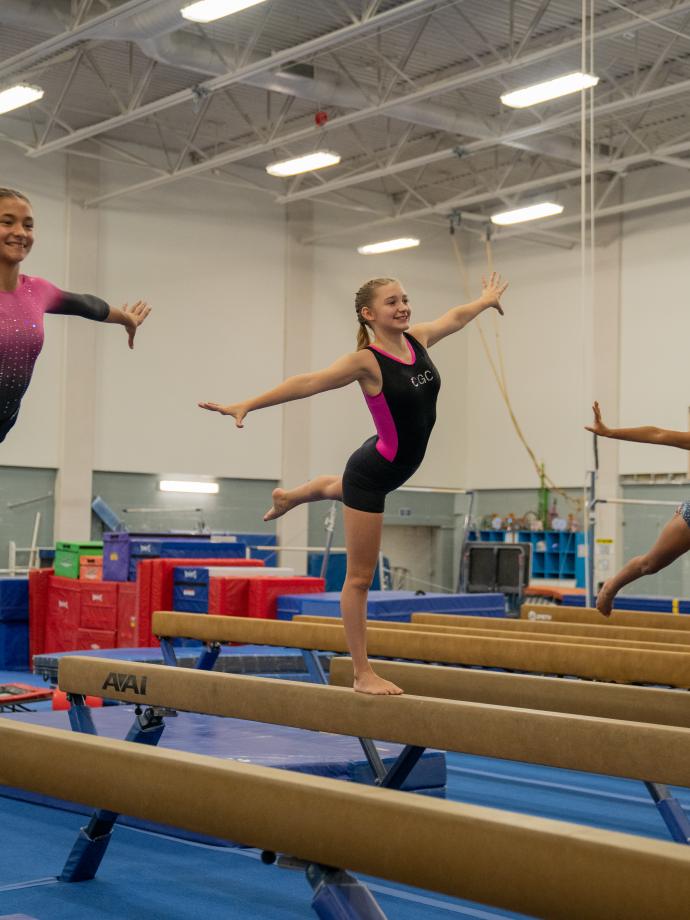 High beam practice at gymnastics clinic
