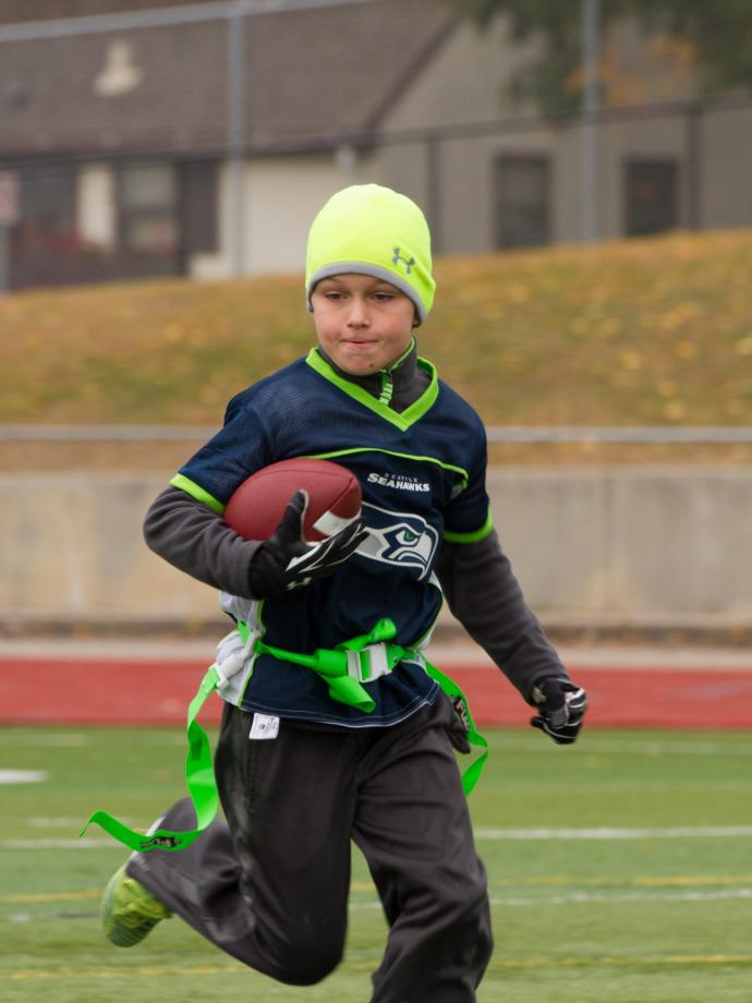 Flag football participant running the ball