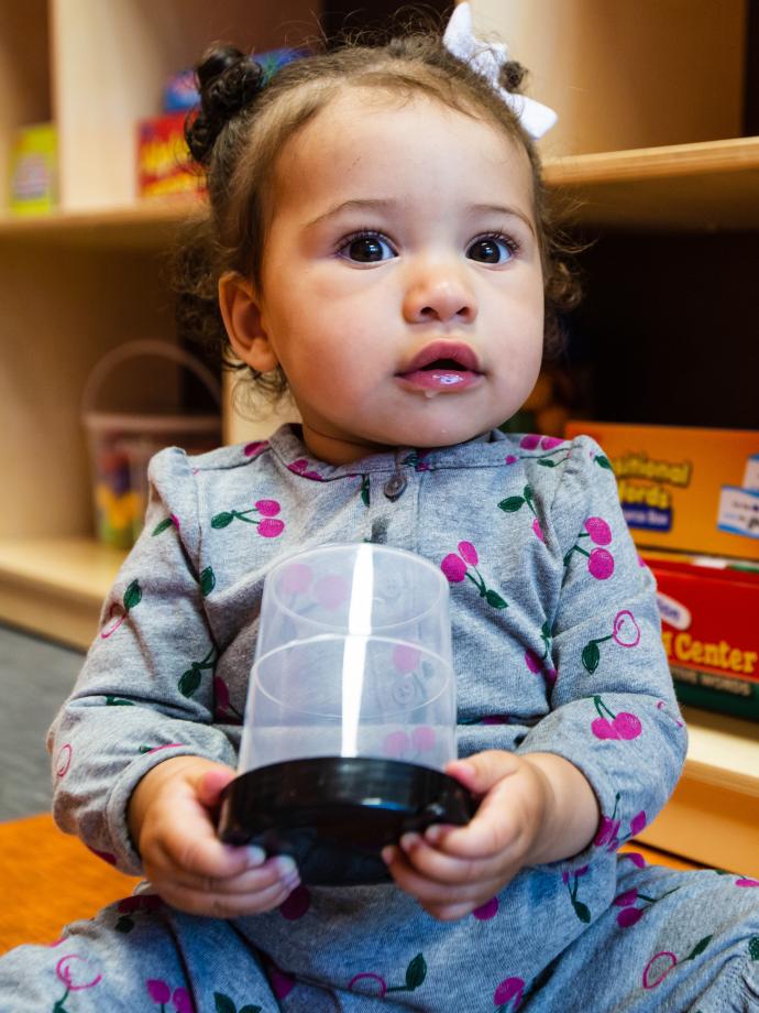 Infant engaging in floor play