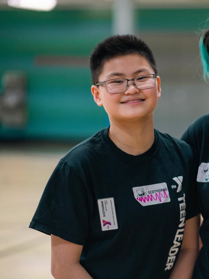 Teen Leaders pose in the gym of a YMCA