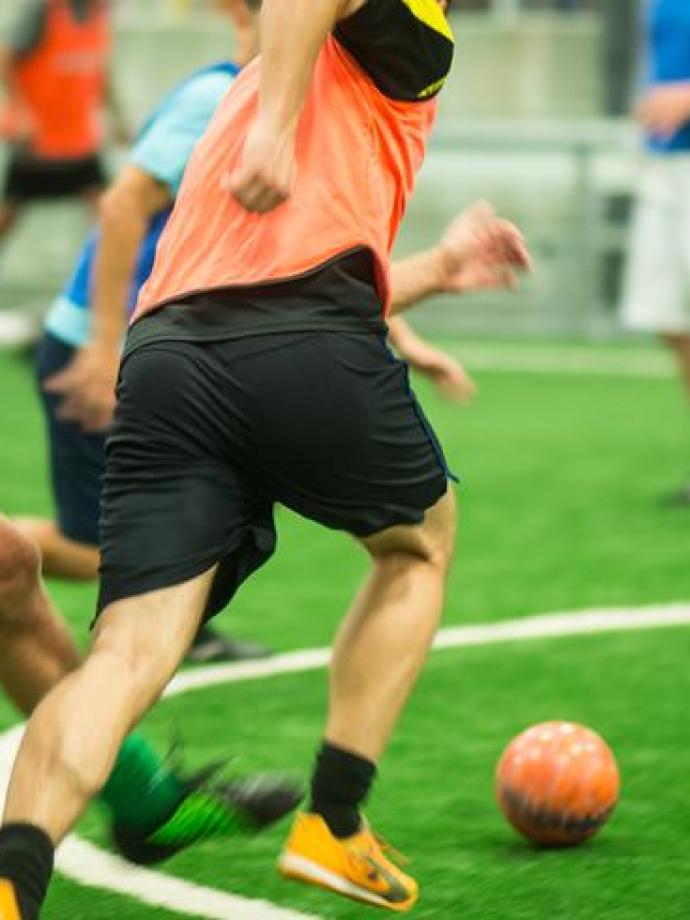 Action shot of a soccer dribbler passing opposing defense at the YMCA