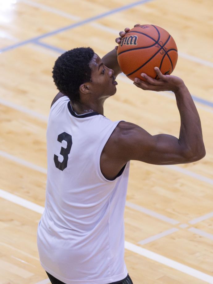 Action shot of a ymca basketball player lining up for a free throw.