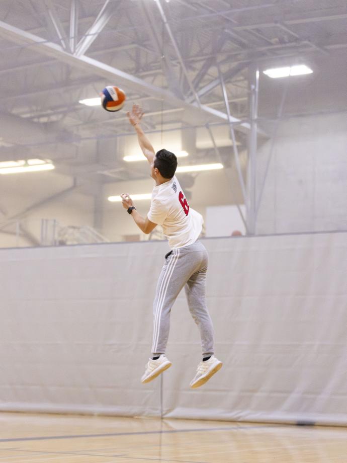 Action shot of a serve at YMCA volleyball