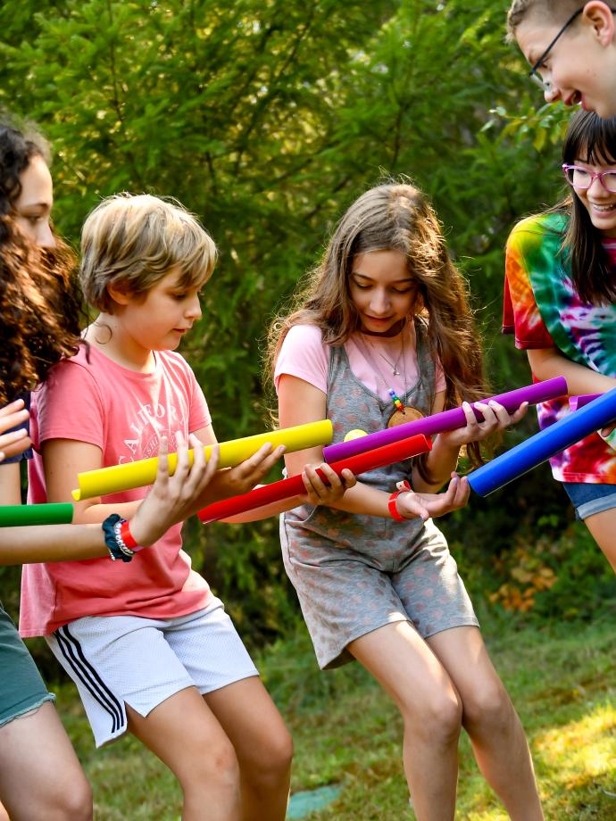 YMCA Camp Lake Helena participants engage in a team building exercise.
