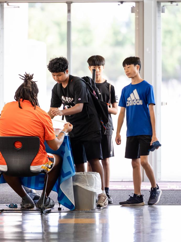 Late Nite teens check in at the welcome desk at the YMCA