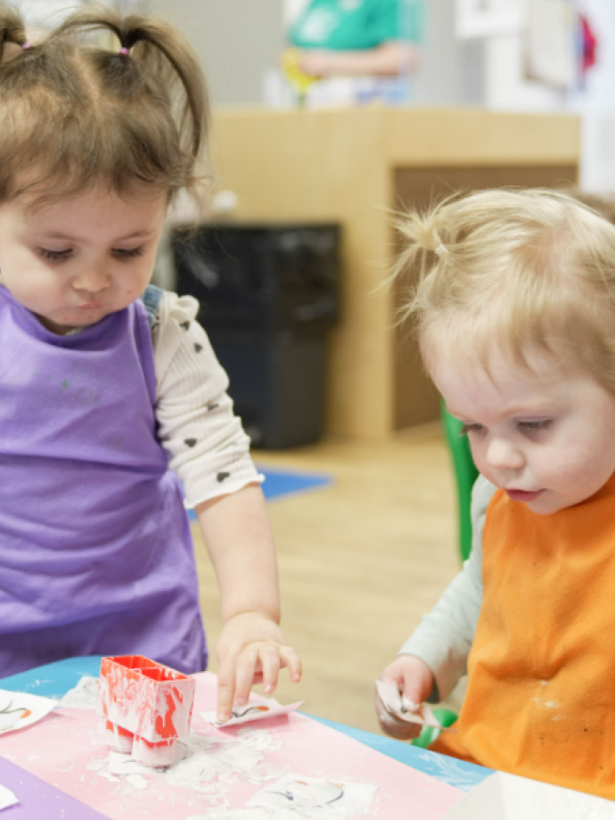 Early Learning Center students play during craft time at the YMCA