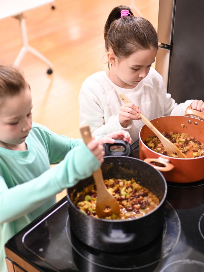 Culinary students mix the chili they made in class at the YMCA