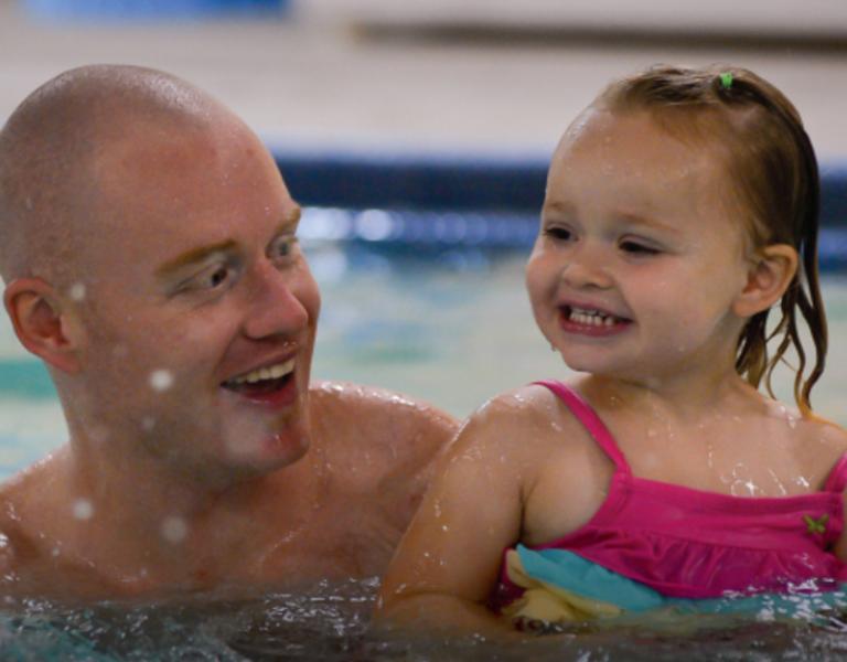 Father and daughter swimming