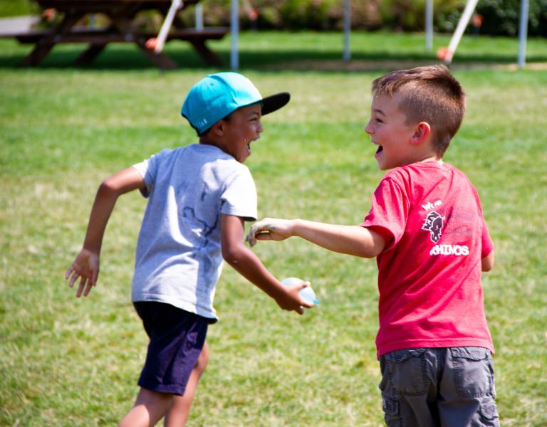 Water Balloon Fight At Summer Day Camp