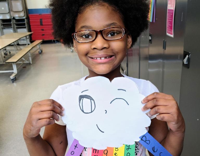 Girl Showing Off Art in YMCA Visual Arts Class