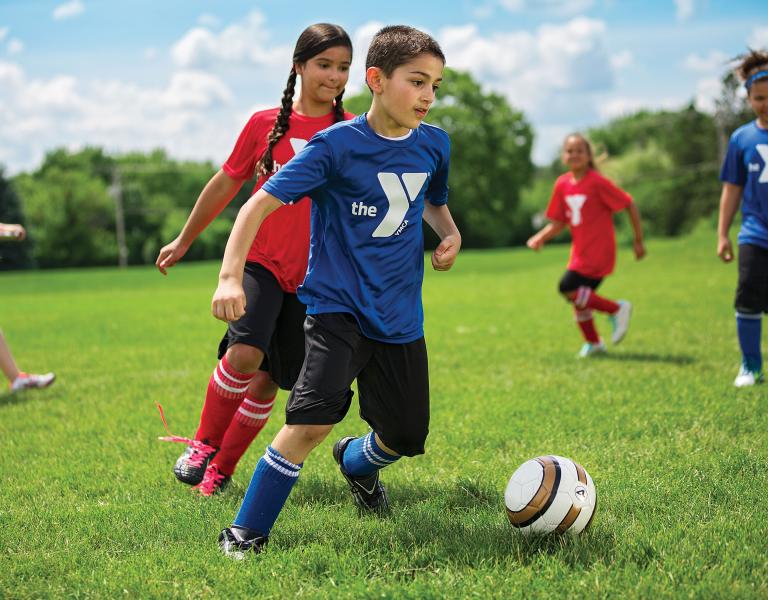 YMCA Youth Soccer Dribbling Down The Field