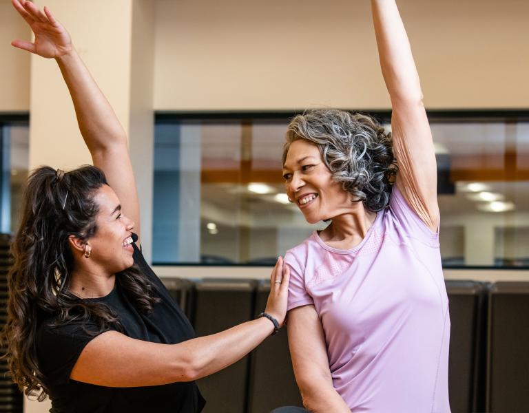 Active Older Adult Stretching In YMCA Group Exercise Class