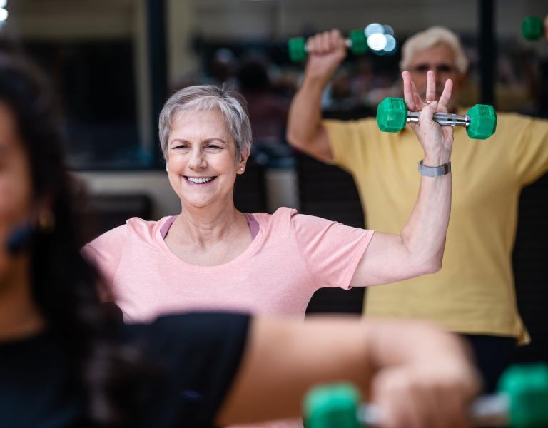 Active Older Adults Shoulder Press In YMCA Group Exercise Class