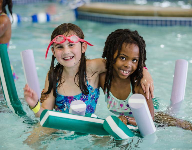 Friends Hugging At YMCA Pool